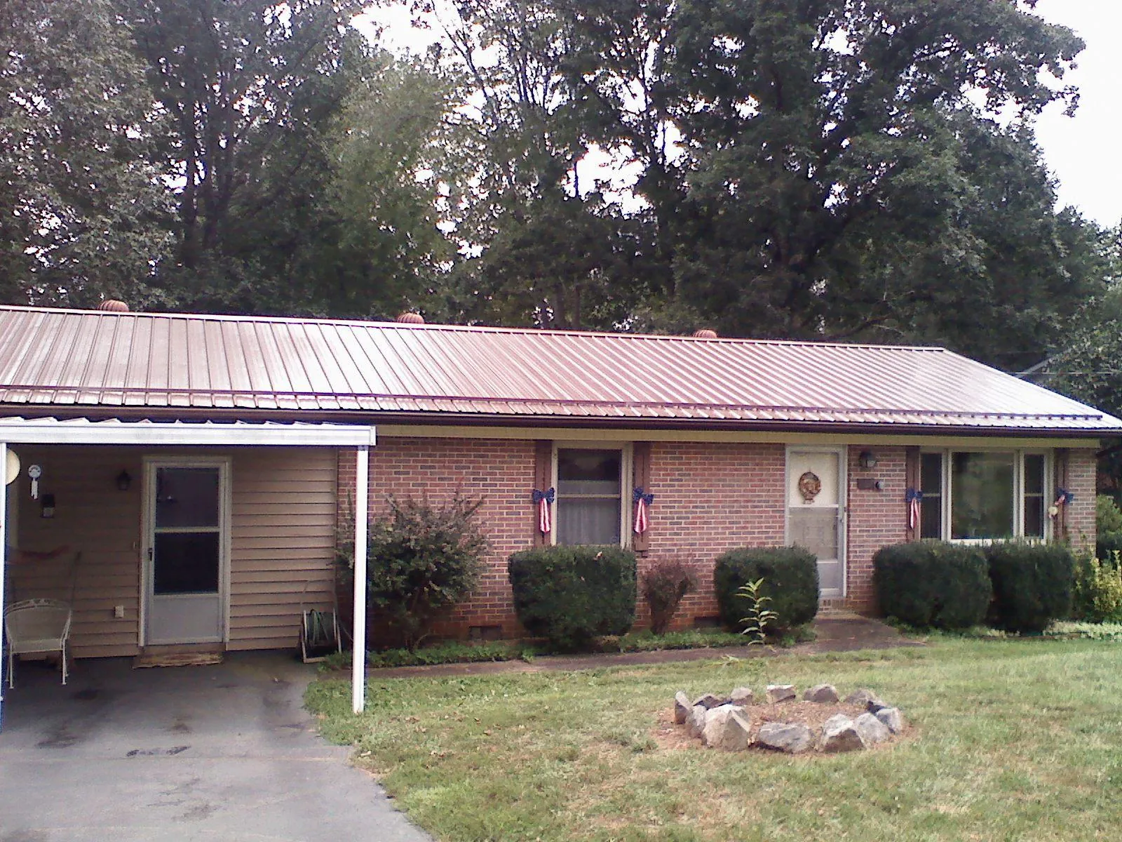 Bronze metal roof and carport on a brick ranch home — Roof Repair work by our crew in Pescadero